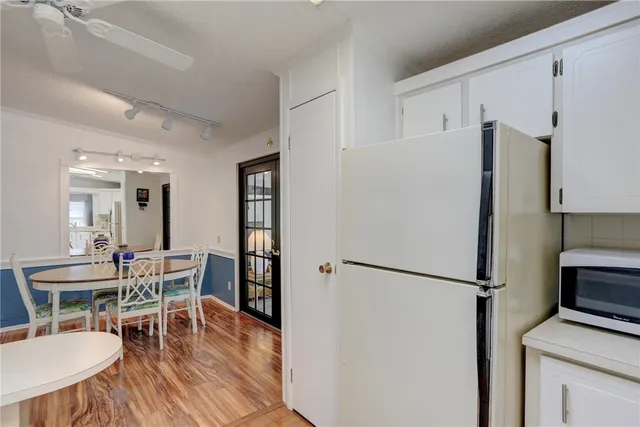 a dining room with furniture window and wooden floor