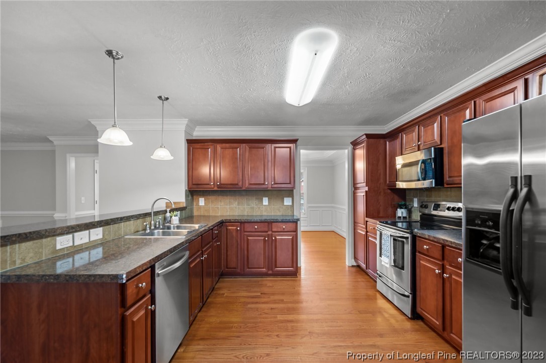 195 Culpepper Road Cameron, NC 28326 - Photo 12 of 46 a kitchen with stainless steel appliances granite countertop a sink stove and refrigerator