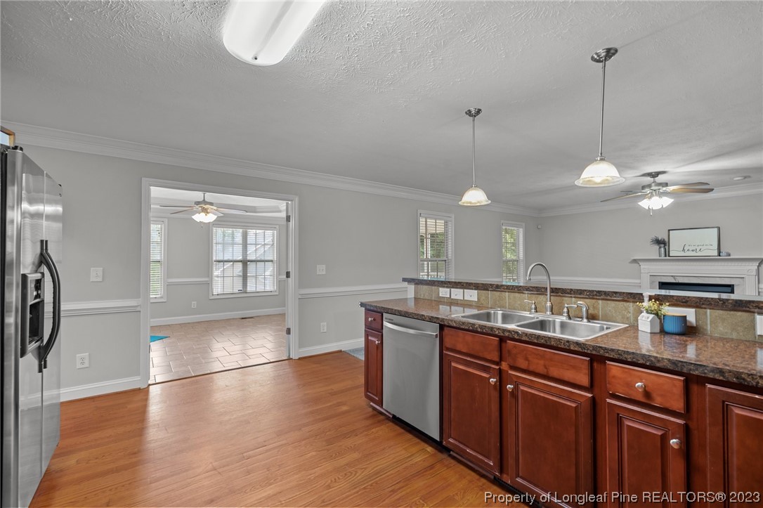 195 Culpepper Road Cameron, NC 28326 - Photo 15 of 46 a kitchen with stainless steel appliances granite countertop a sink a oven a refrigerator and a wooden floors