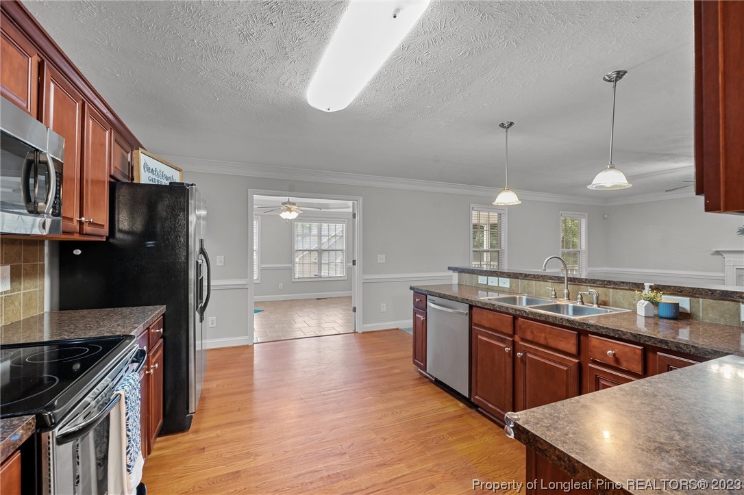 195 Culpepper Road Cameron, NC 28326 - Photo 16 of 46 a kitchen with stainless steel appliances granite countertop a stove a sink and a refrigerator