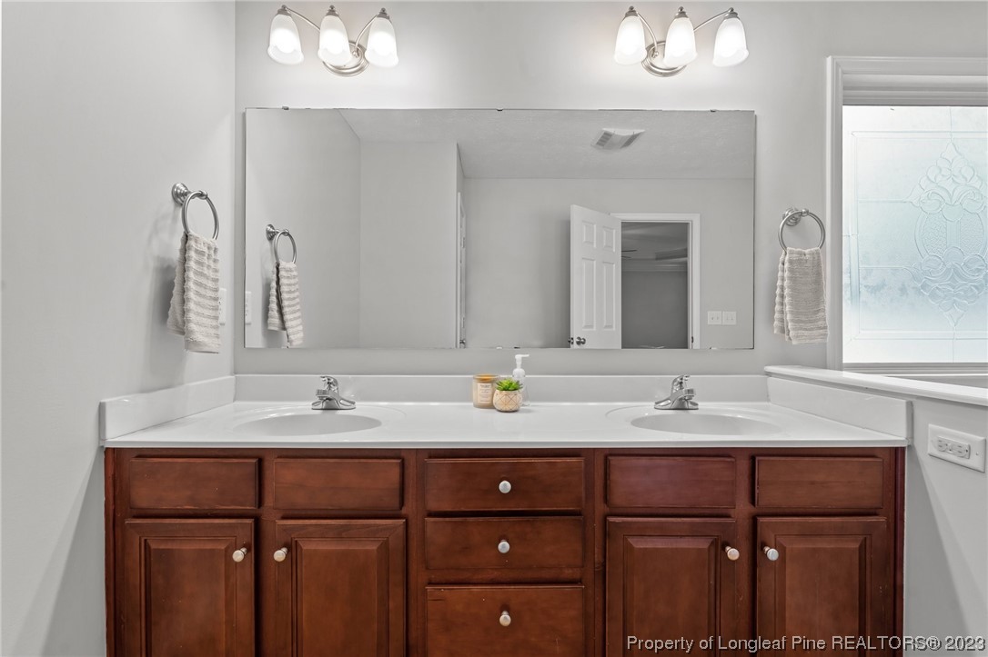 195 Culpepper Road Cameron, NC 28326 - Photo 25 of 46 a bathroom with a double vanity sink and mirror