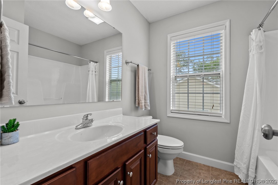 195 Culpepper Road Cameron, NC 28326 - Photo 33 of 46 a bathroom with a granite countertop sink toilet a large mirror and shower
