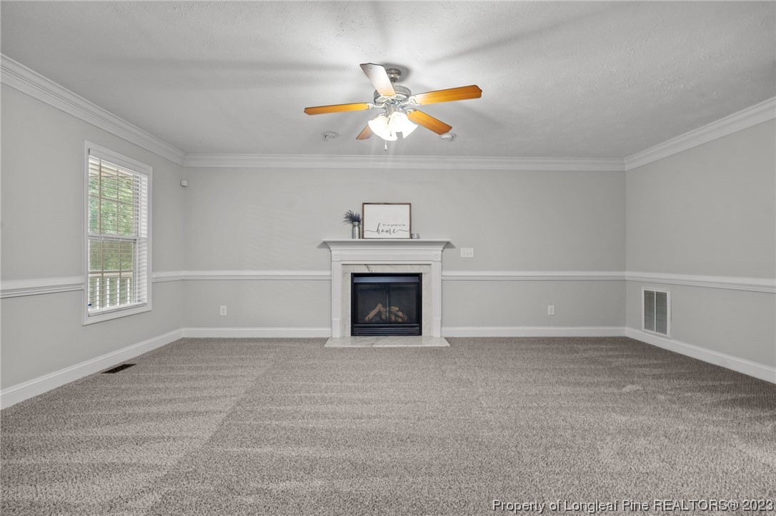 195 Culpepper Road Cameron, NC 28326 - Photo 7 of 46 a view of livingroom with a fireplace ceiling fan and window