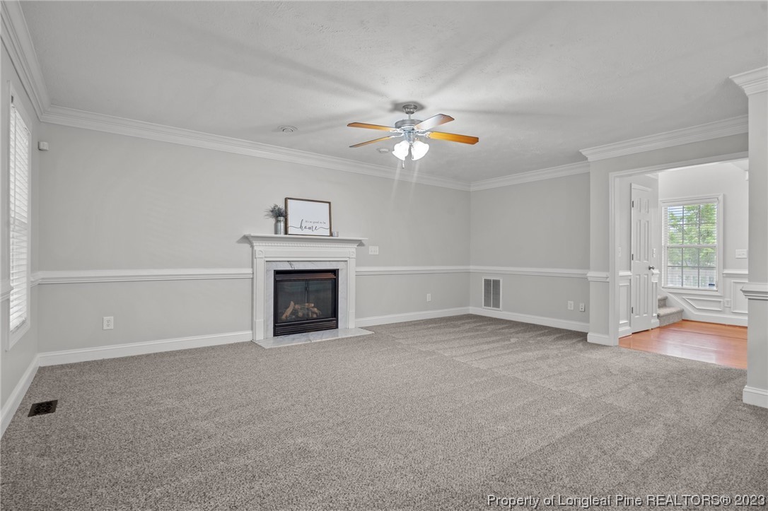 195 Culpepper Road Cameron, NC 28326 - Photo 10 of 46 an empty room with fireplace and fan