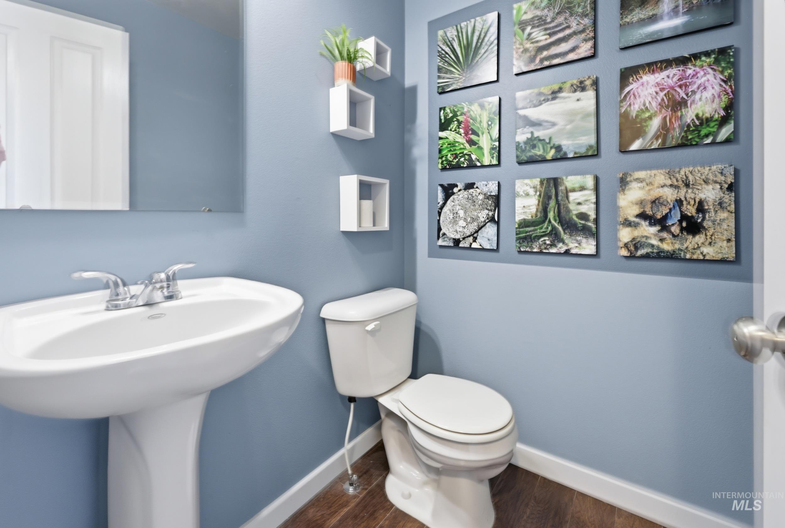 4855 South Chex Way Boise, ID 83709 - Photo 26 of 47 Pedestal sink with chrome fixtures and a rectangular mirror