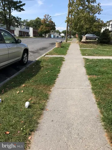 a view of a street with parked cars