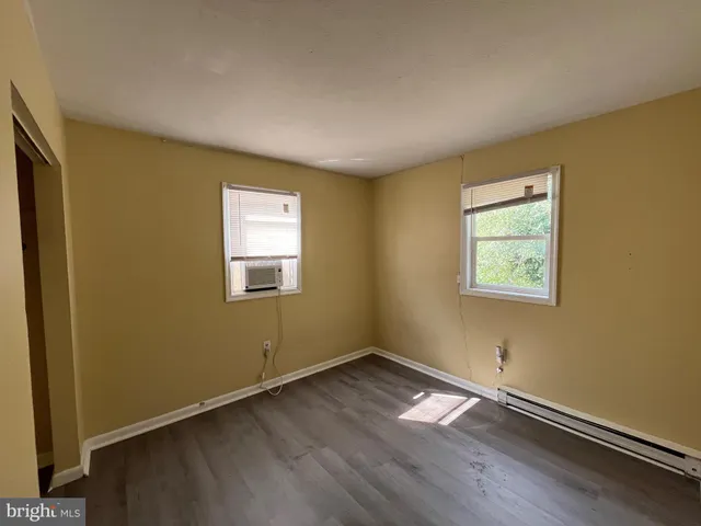 a view of a room with wooden floor and windows