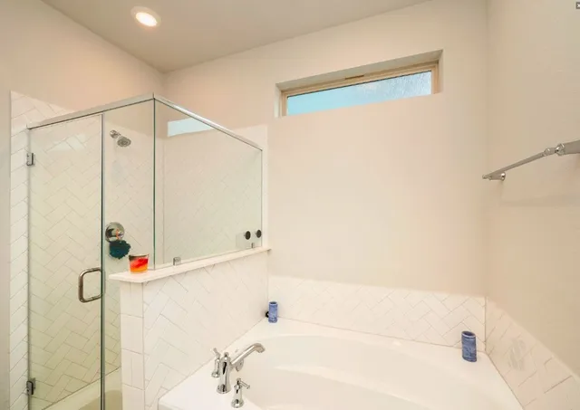 a bathroom with a bathtub and a shower