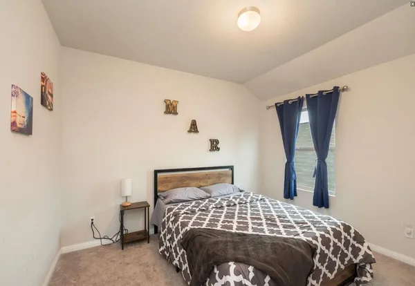 a bedroom with a bed and a mirror