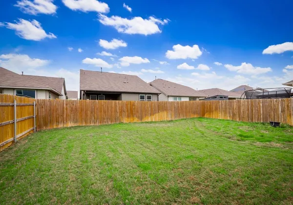 a view of a yard with swimming pool in front of house