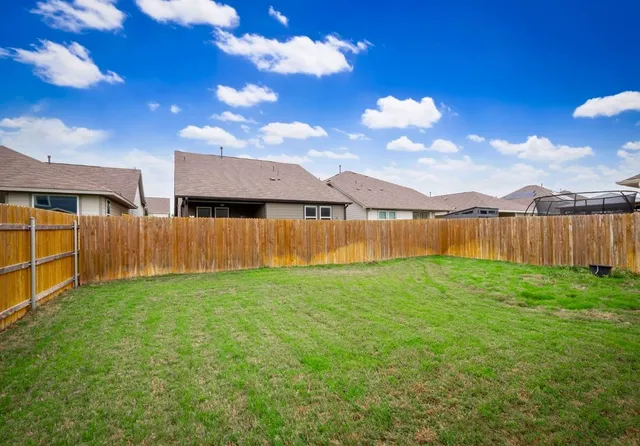 a view of a yard with swimming pool in front of house