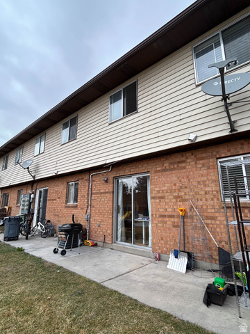 939 South Freedom Boulevard, Unit 13 Provo, UT 84601 - Photo 23 of 26 Back of house featuring a patio area, brick siding, and a yard
