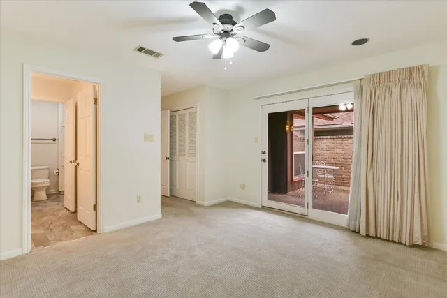 a view of an empty room and closet area