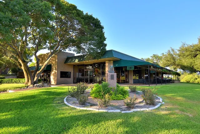 a front view of a house with a yard porch and outdoor seating