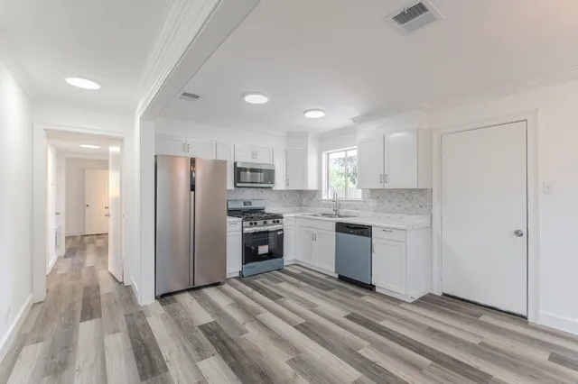 a kitchen with a refrigerator and a sink