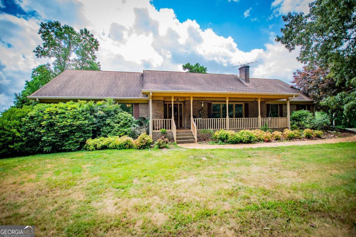 1701 Pleasant Ridge Road Carrollton, GA 30117 - Photo 1 of 1 a view of a house with a garden and plants