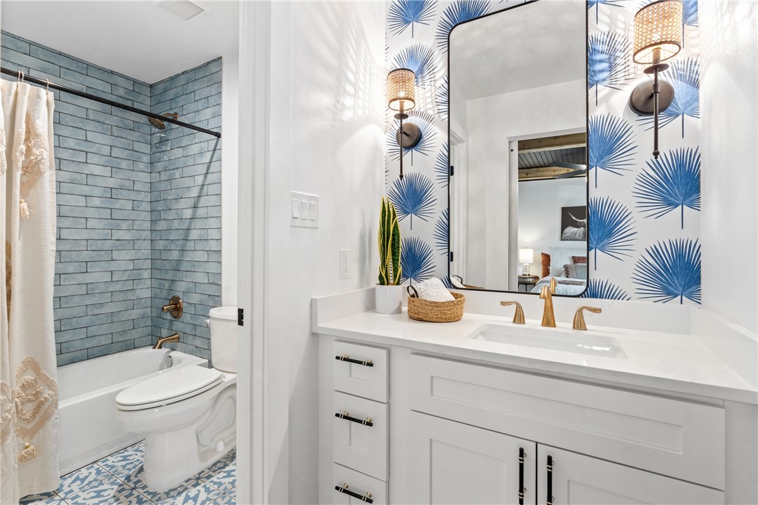 3808 Leafield Drive Austin, TX 78749 - Photo 18 of 31 a bathroom with a granite countertop sink vanity mirror and toilet