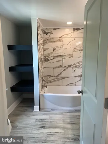 a bathroom with a bathtub and shower