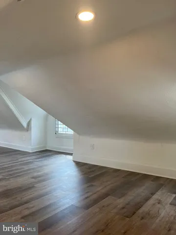 a view of an empty room and wooden floor
