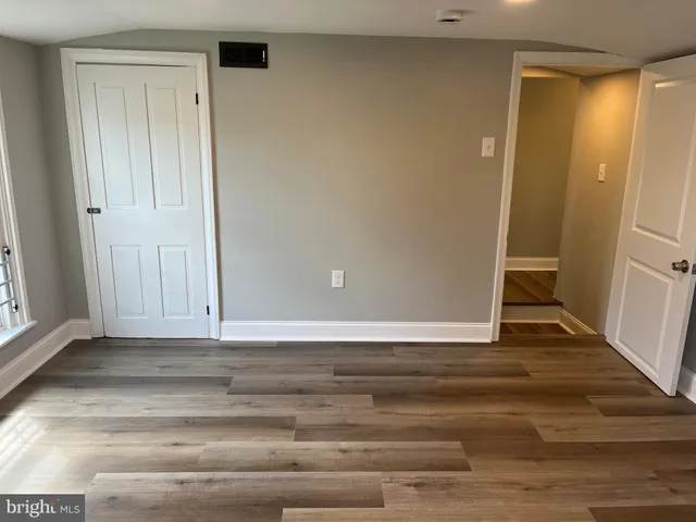 a view of room with window and wooden floor