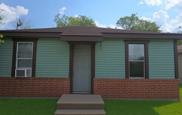 a view of a house with a small yard