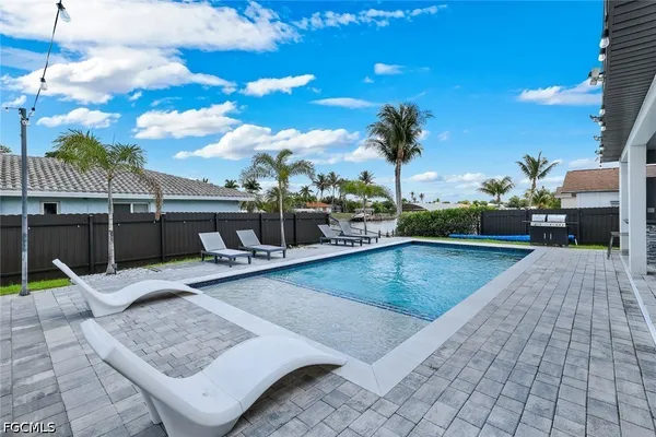 a view of a swimming pool with a patio