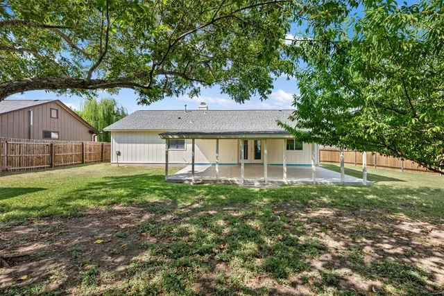 a view of house with backyard and garden