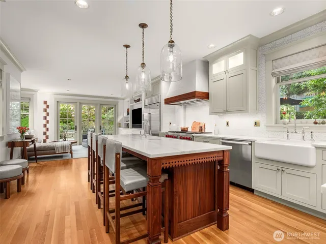 a open kitchen with stainless steel appliances granite countertop a lot of counter space and a wooden floor