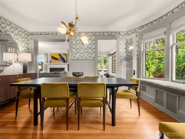 a view of a dining room with furniture a chandelier and wooden floor