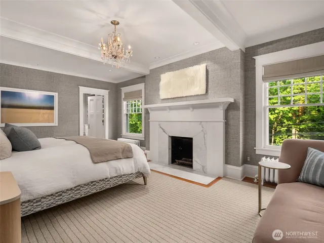 a spacious bedroom with a large bed and a fireplace