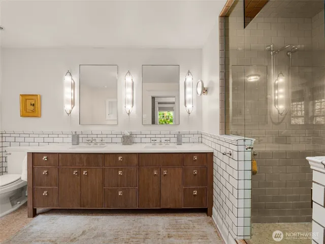 a bathroom with a double vanity sink mirror and double
