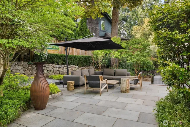a view of backyard with outdoor seating and trees