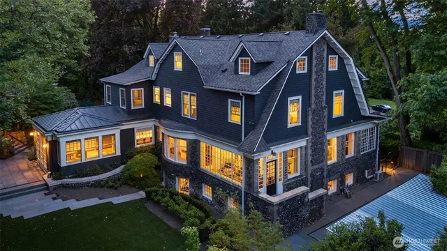 a aerial view of a brick house next to a yard