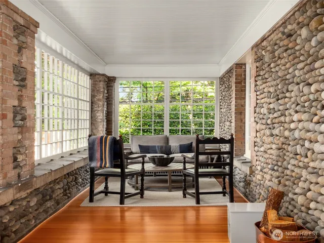 a living room with furniture and floor to ceiling windows