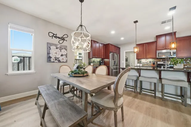a bed sitting in a spacious bedroom next to a window