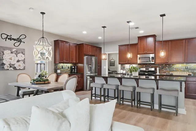 a large kitchen with a table and chairs