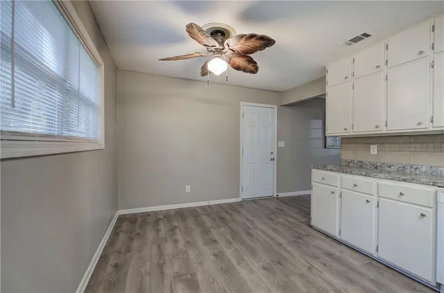 a view of kitchen with granite countertop cabinets a sink and dishwasher