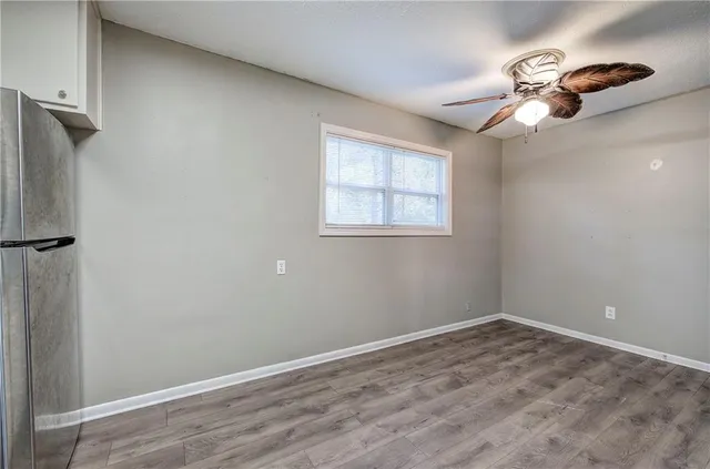 a view of a room that has a window and wooden floor