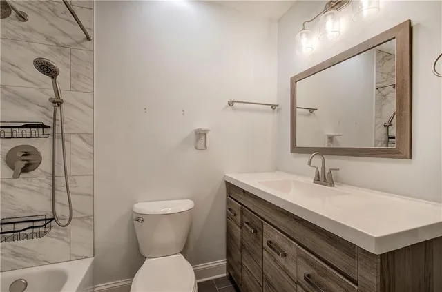 a bathroom with a sink toilet and a mirror