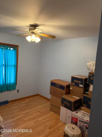 a room with wooden floor and shoes