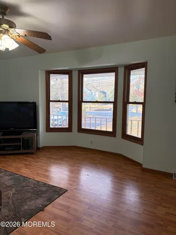 a view of an empty room with glass door and windows