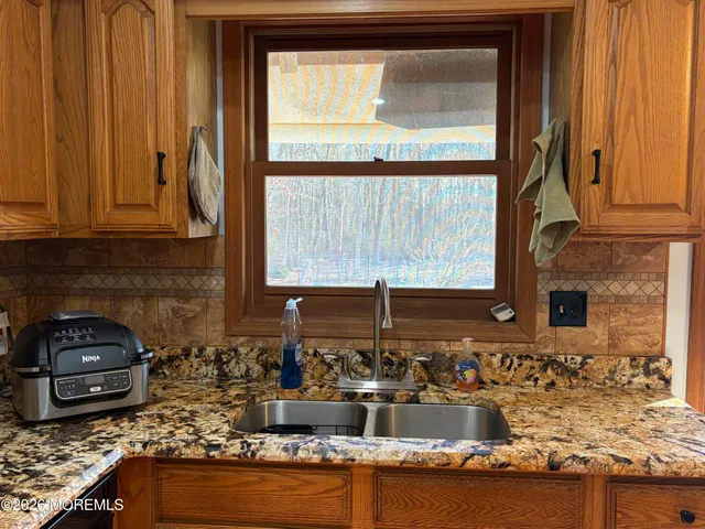 a kitchen with granite countertop a stove and a microwave