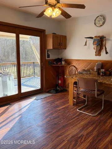 a view of a livingroom with furniture wooden floor and windows