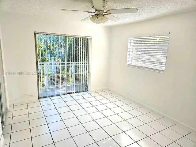 a view of an empty room and a window
