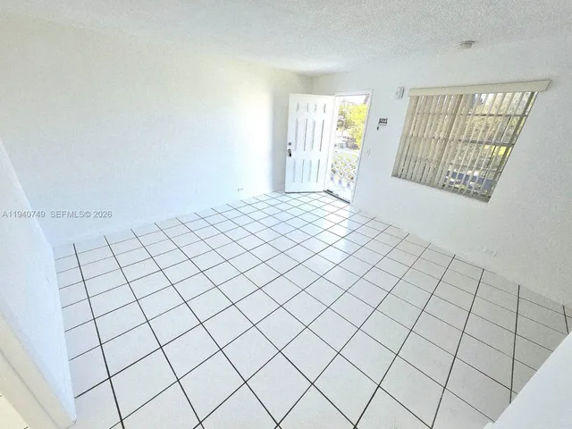 a view of an empty room and window