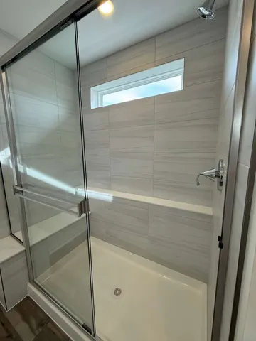 a bathroom with a glass shower door