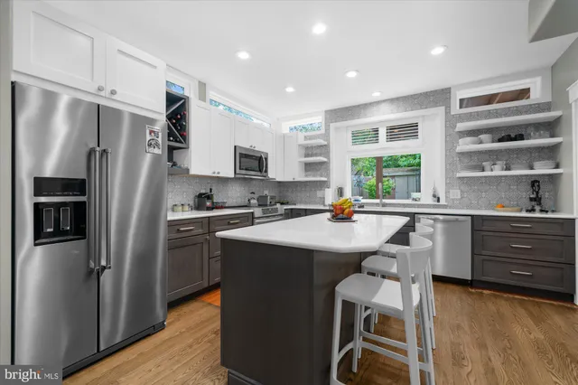 a kitchen with refrigerator cabinets and microwave