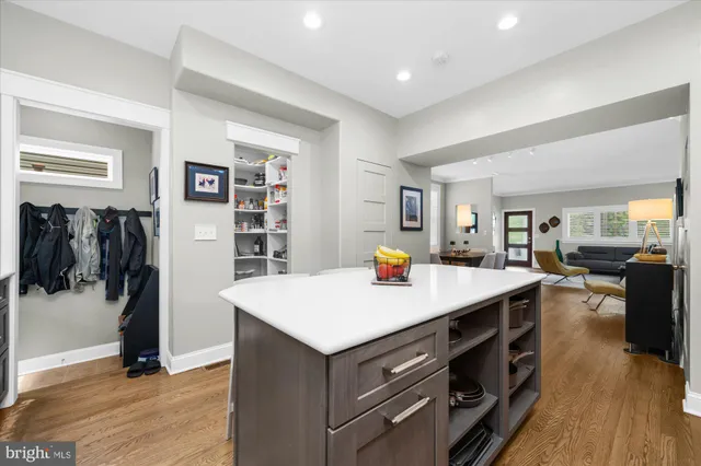 a view of kitchen with stainless steel appliances kitchen island a refrigerator and a counter space