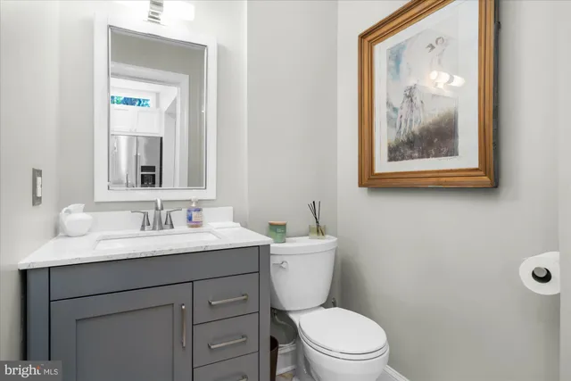 a bathroom with a toilet a sink and mirror