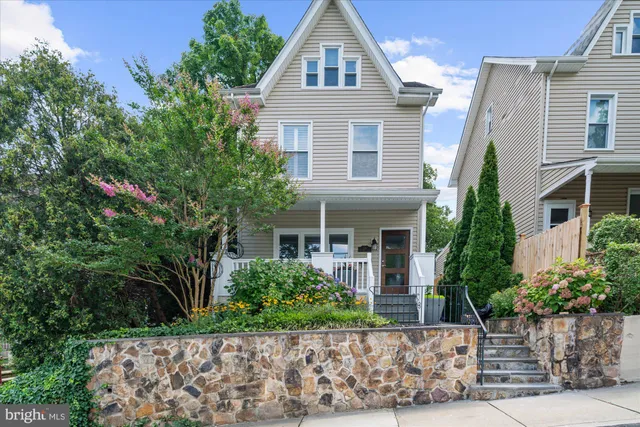 a front view of a house with plants